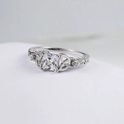 Ring met strikdesign en edelsteen in het midden in goud