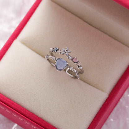 Verstelbare ring met blauwe steen in wit goud