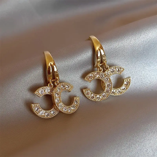 Glinsterende signature-oorbellen | Goud