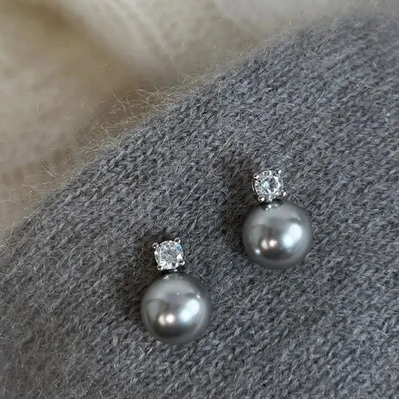 Elegante zwarte parel-oorbellen met steentjes in goud