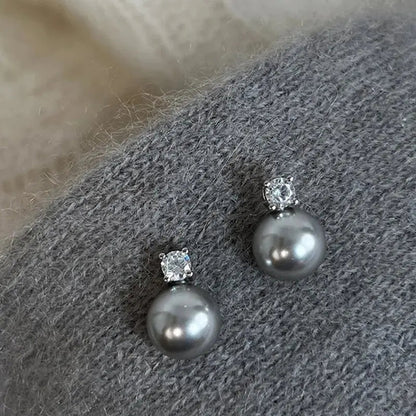 Elegante zwarte parel-oorbellen met steentjes in goud
