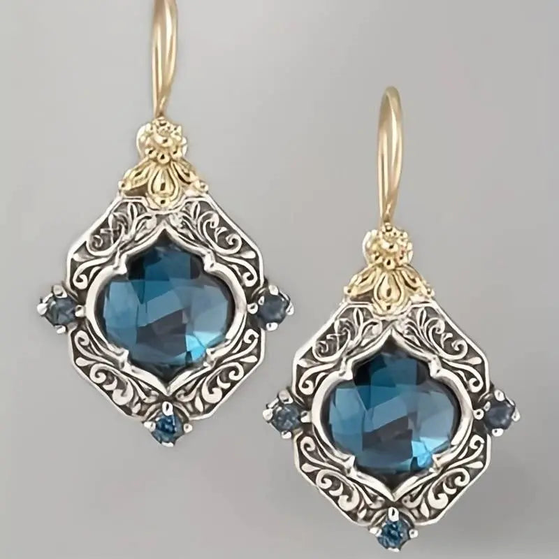 Oorbellen met blauwe kristallen in goud
