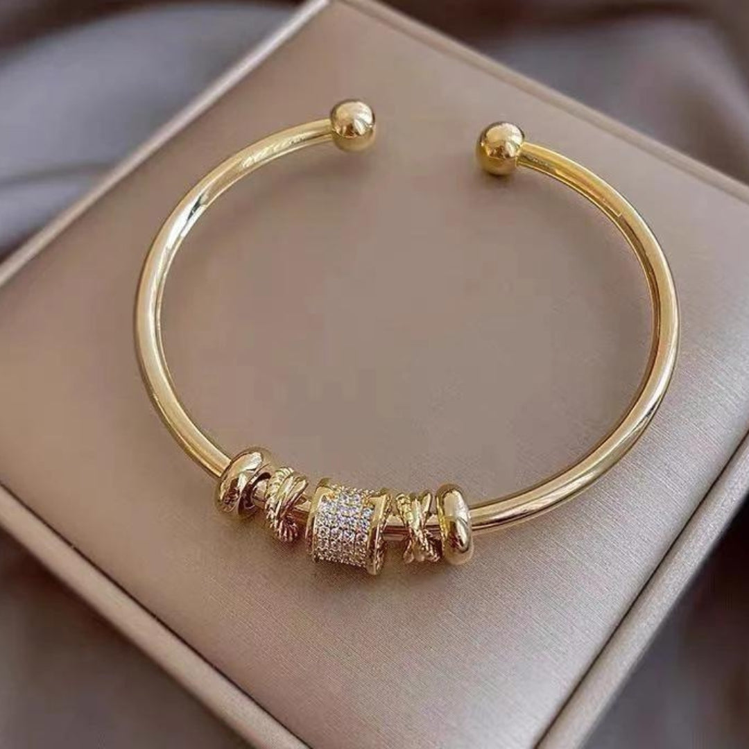 Verstelbare armband met bedels in goud