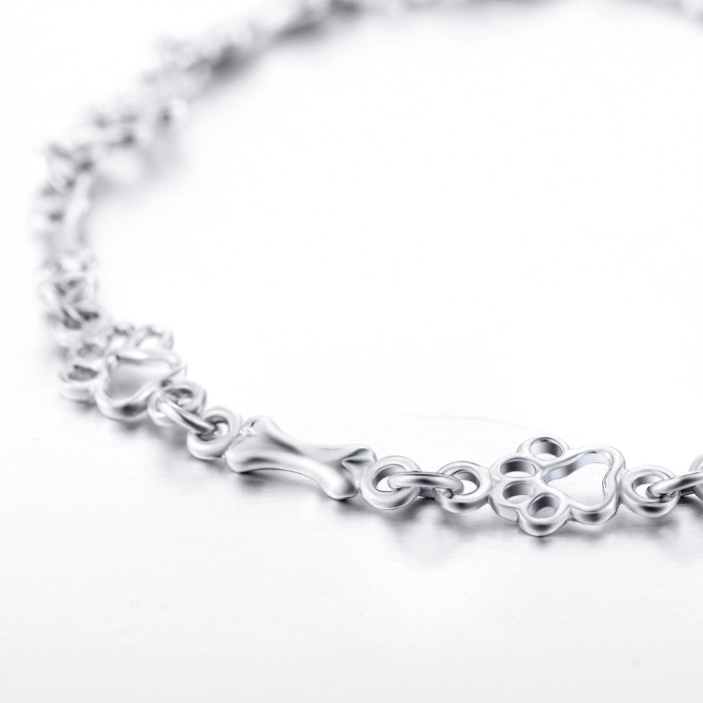 Armband met hondenpootjes en botje, gelimiteerde oplage | Witgoud