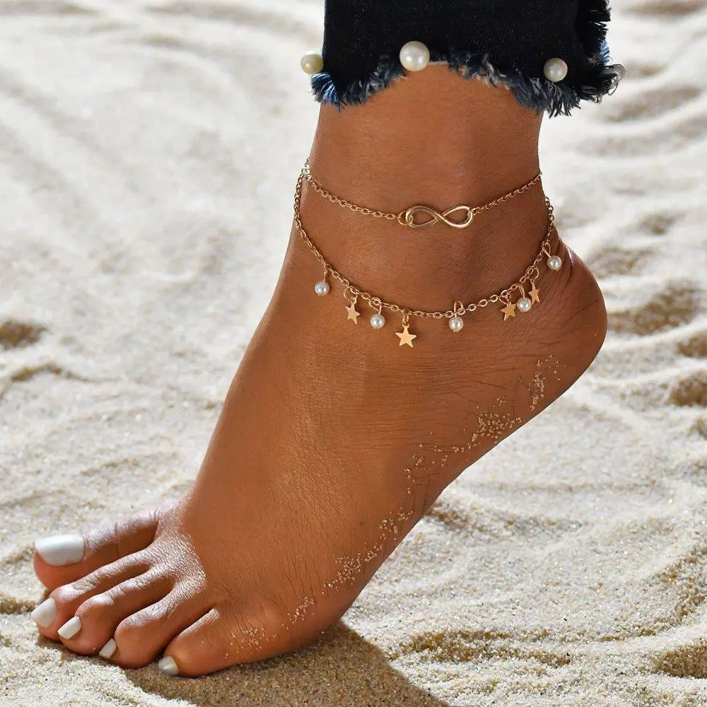 Armband met infinity-koord, parels en sterren in goud