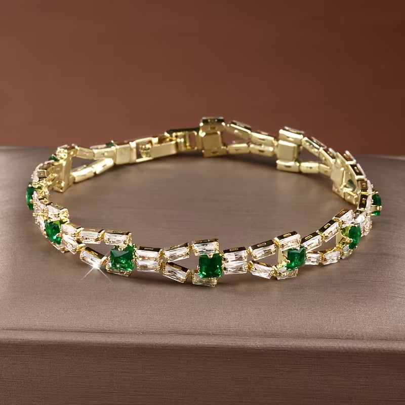 Groene tennisarmband met schakels in goud
