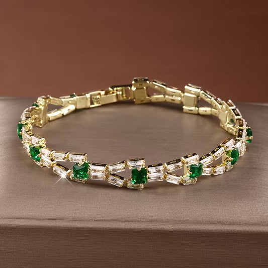 Groene tennisarmband met schakels in goud