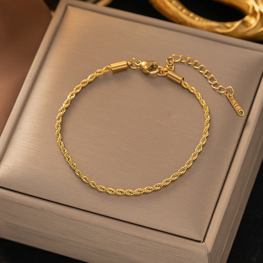 Gedraaide schakelarmband in goud