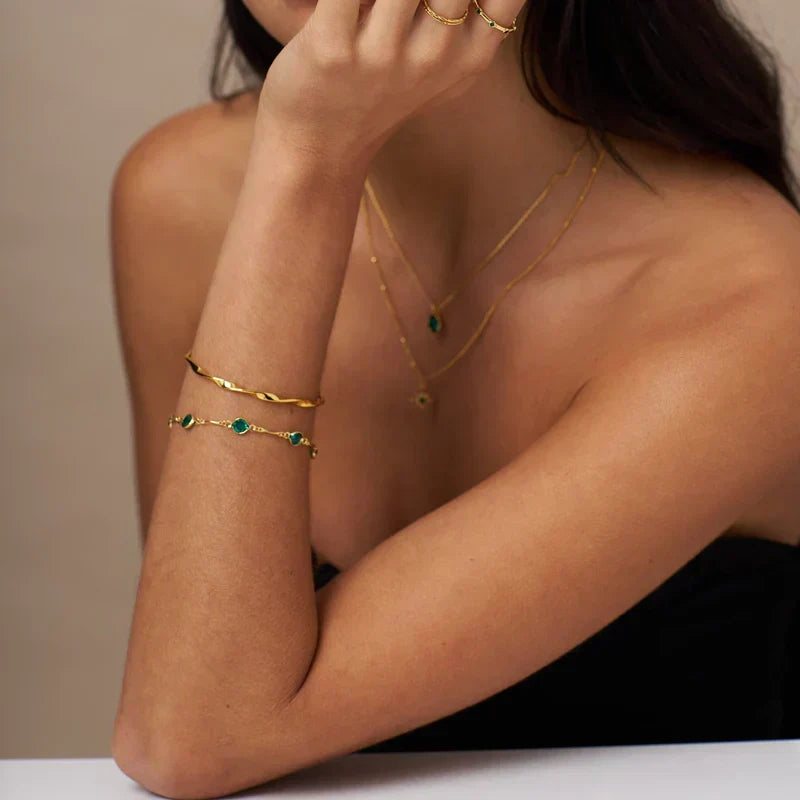 Smaragd schakelarmband in goud