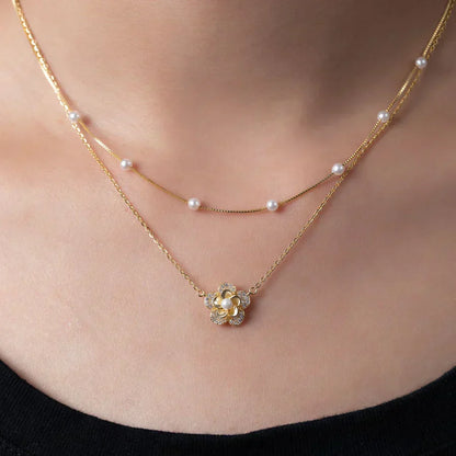 Bloemenketting met dubbele parels in goud