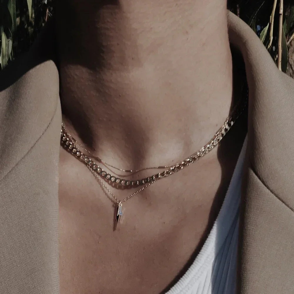 Platte schakelketting in goud