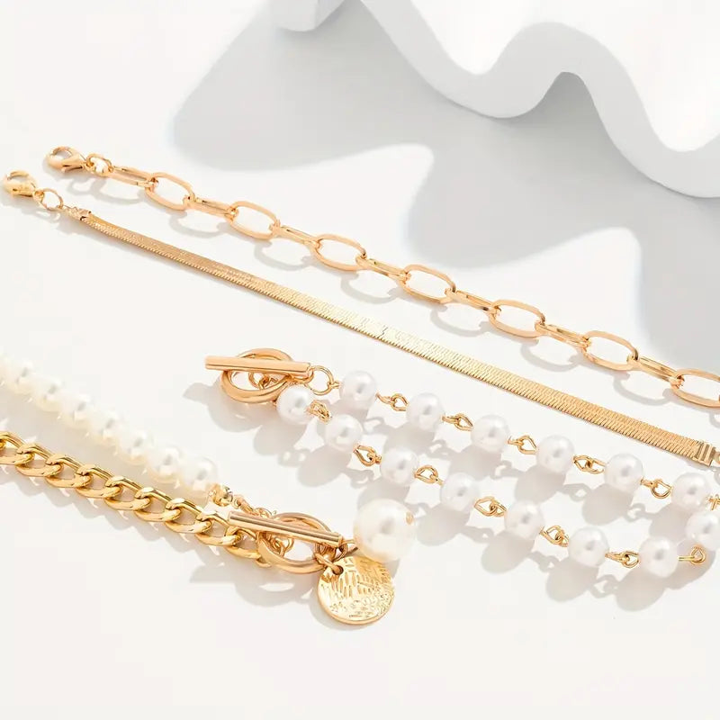 Chique armbandenset – slang, parels en schakels in goud