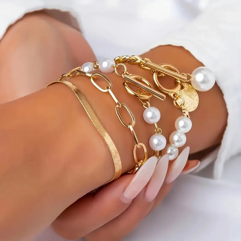 Chique armbandenset – slang, parels en schakels in goud