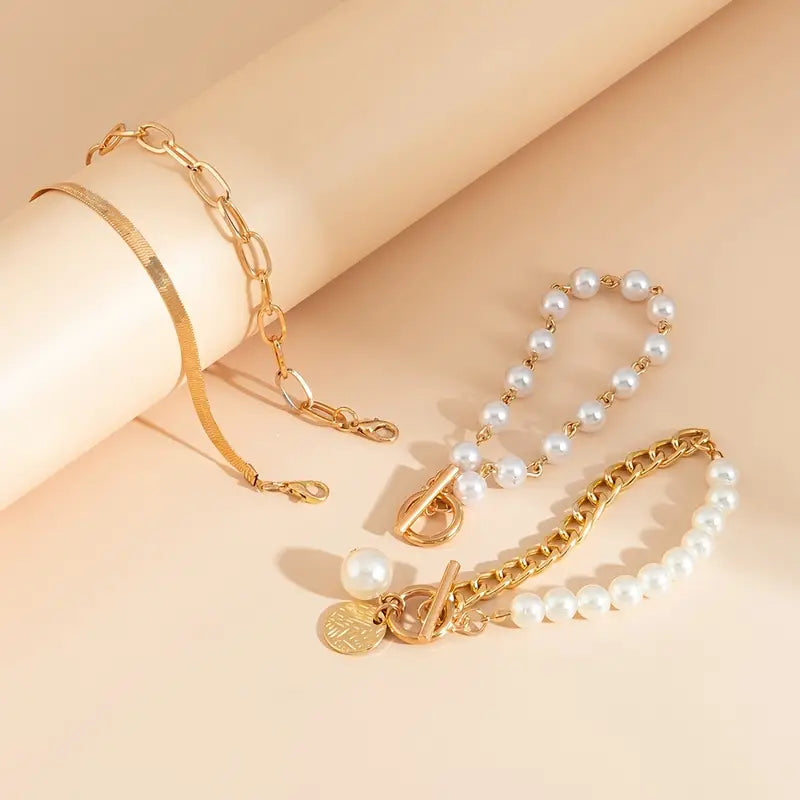 Chique armbandenset – slang, parels en schakels in goud