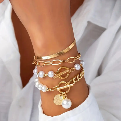 Chique armbandenset – slang, parels en schakels in goud