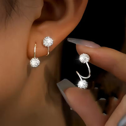 Lichte luxe oorbellenset met spiraalbolletjes en steentjes in goud